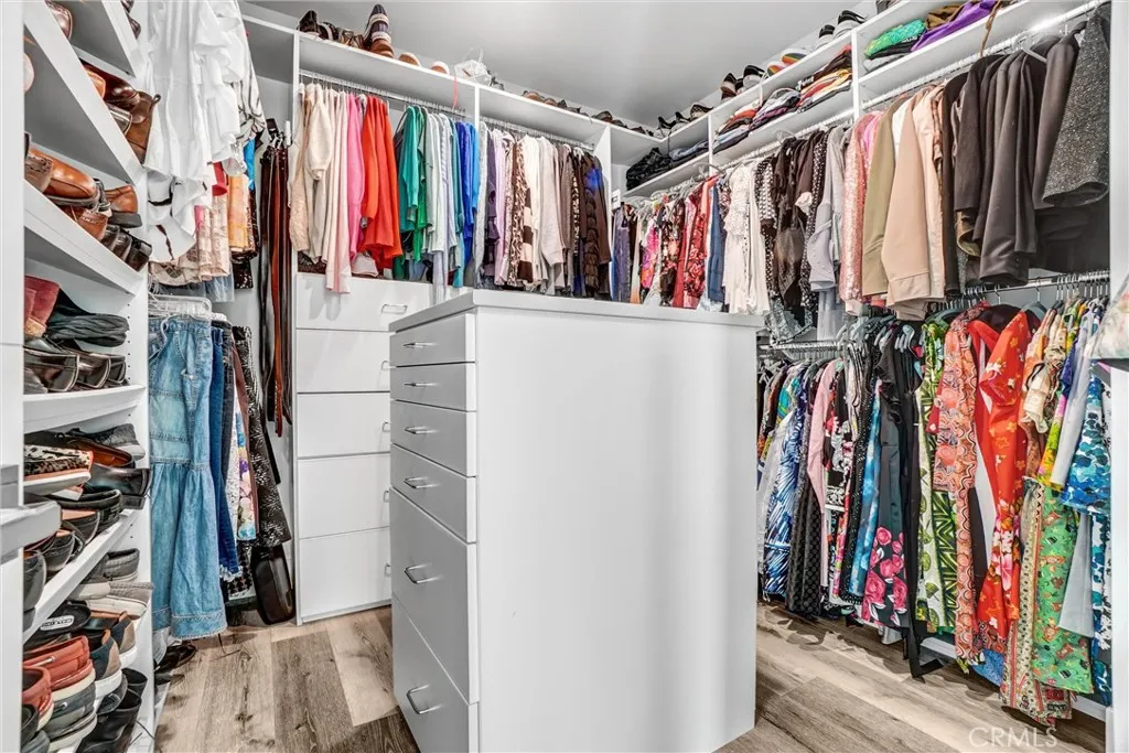 Spacious walk-in closet with custom cabinetry
