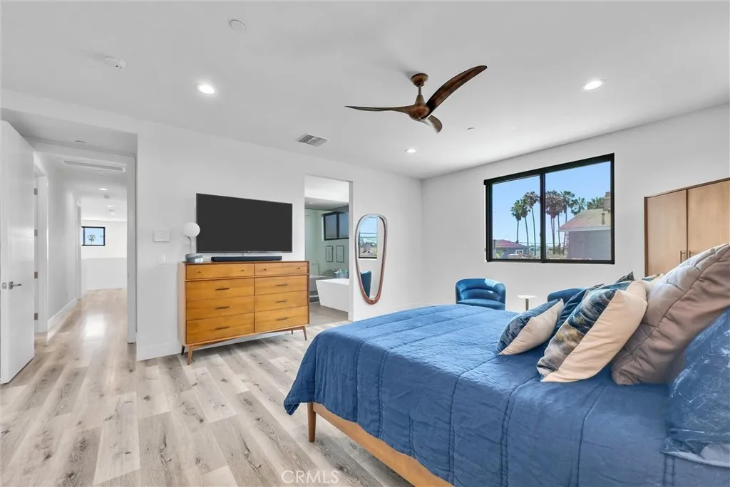 Primary Bedroom with view to beautiful bathroom and upper hallway
