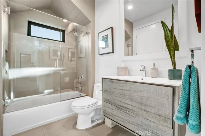 Lower full bathroom with custom cabinetry and tile