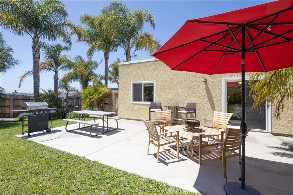 Backyard patio with sliding door into primary bedroom and gate to front yard.