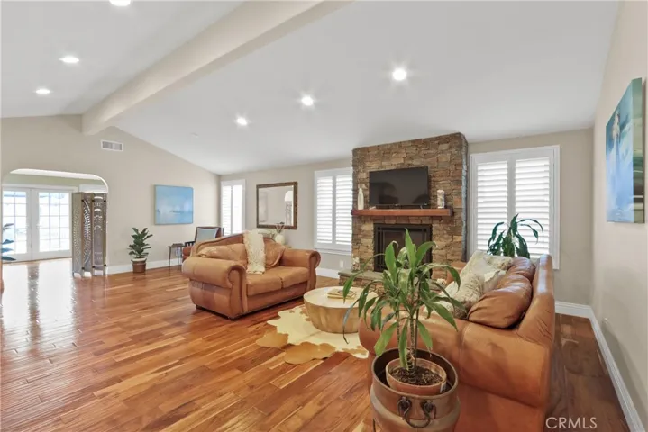 Living room with stone faced fireplace.