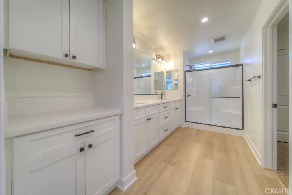 The primary bathroom includes dual vanities, quartz countertops, a private toilet area, and so much more!
