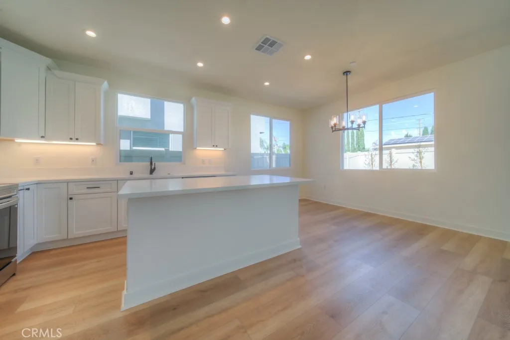 Gourmet kitchen with quartz countertops & stainless-steel appliances.