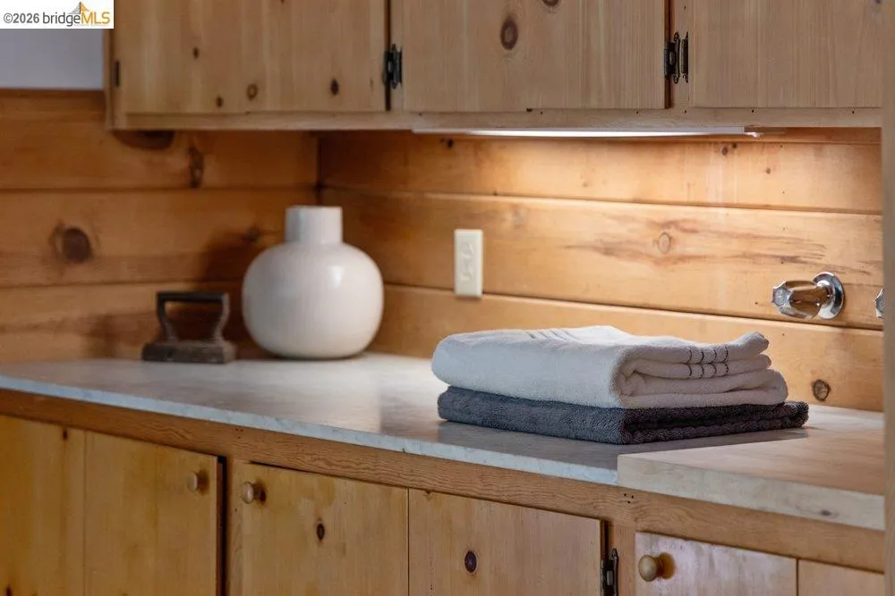 Custom knotty pine cabinetry featuring wood knobs and integrated under-cabinet lighting