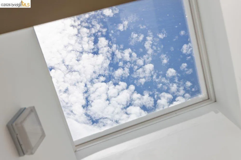 Recessed skylight with white trim and a white ceiling