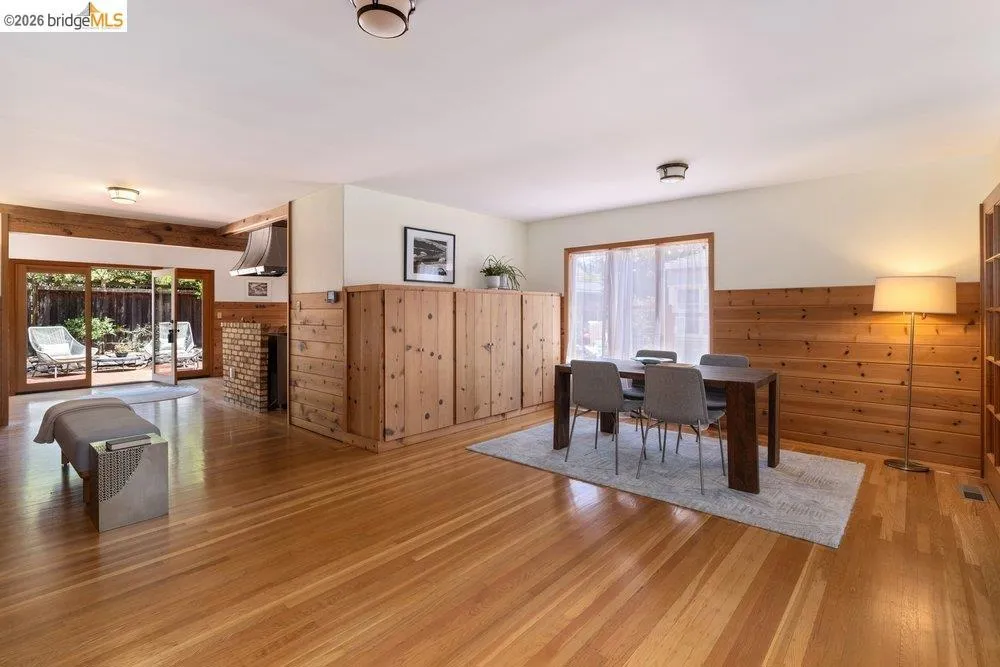 Hardwood flooring extends throughout this interior space featuring substantial wood paneling