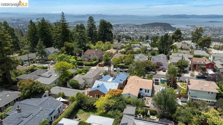 Hillside residential area featuring a variety of homes with diverse architectural styles and roof finishes