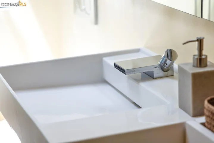 White rectangular vessel sink with an integrated chrome faucet