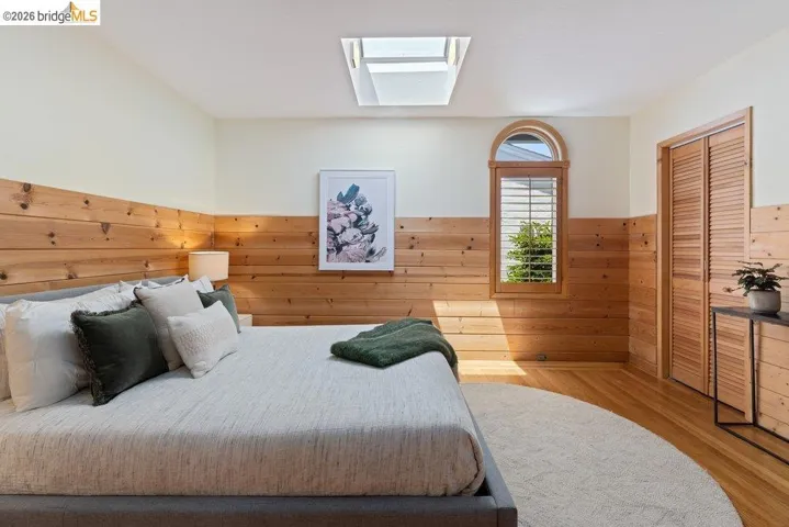 Hardwood flooring and shiplap wall accents create a natural aesthetic