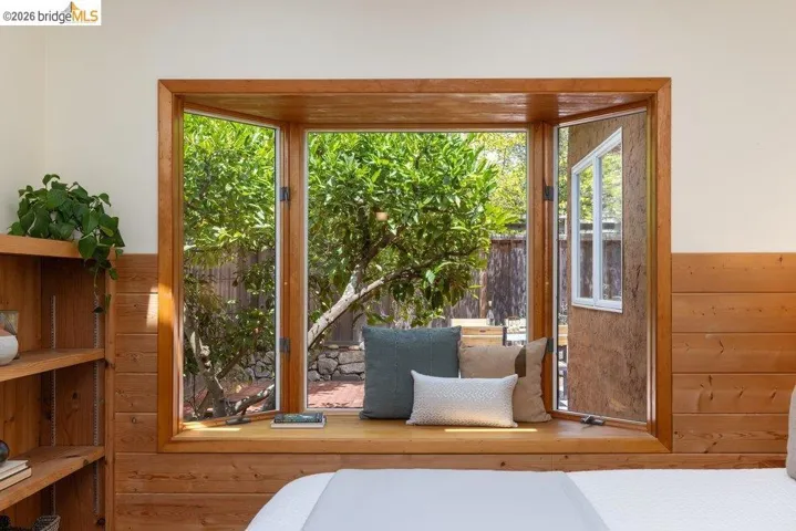 Expansive bay window with a wood-finish frame and deep sill