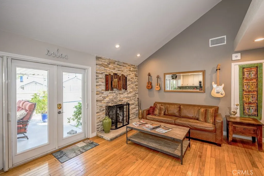 Views to the Family room and through the French Doors with phantom screens to the outside covered patio and pool area