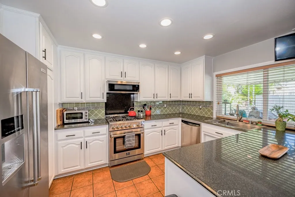 Kitchen with custom farmer style sink, pass through window for service to patio area. Appliances will Stay with the property