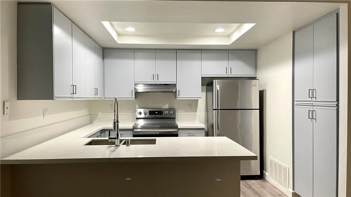 Kitchen opens to Great Room. Pantry on the right. Stainless appliances. Recessed lights.