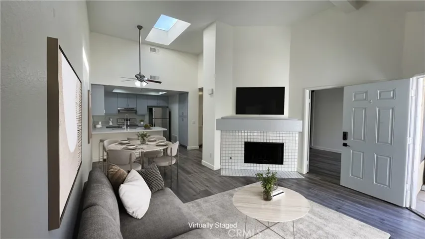 Virtually Staged Photo - Open Floor Plan. TV mount over Fireplace.