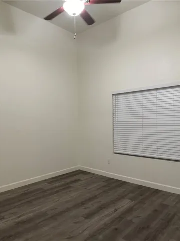 Primary Bedroom with vaulted ceilings and window that open to patio
