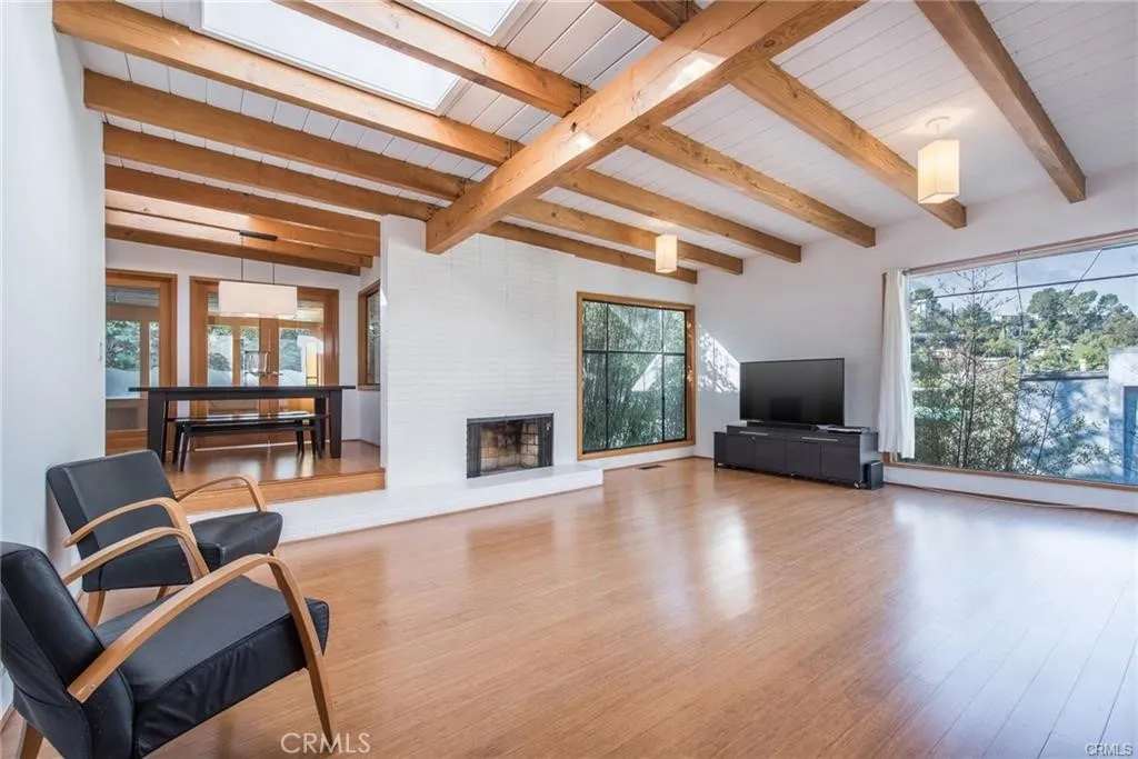 Spacious bright living room with wood beamed ceiling