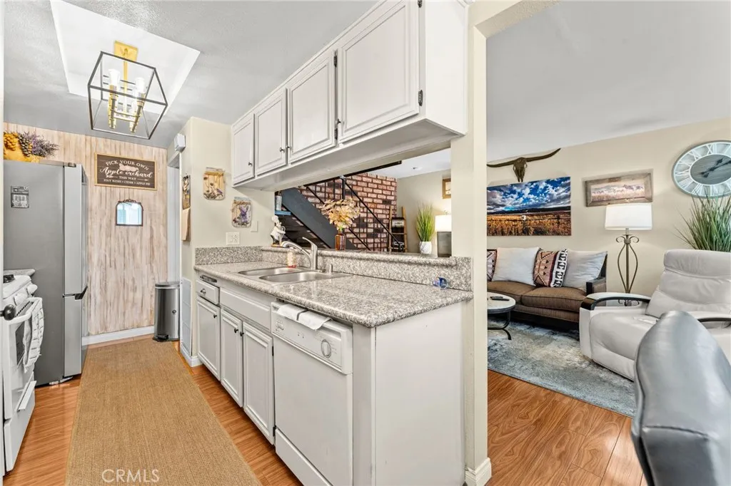 Galley kitchen with granite counter tops and new overhead light fixture