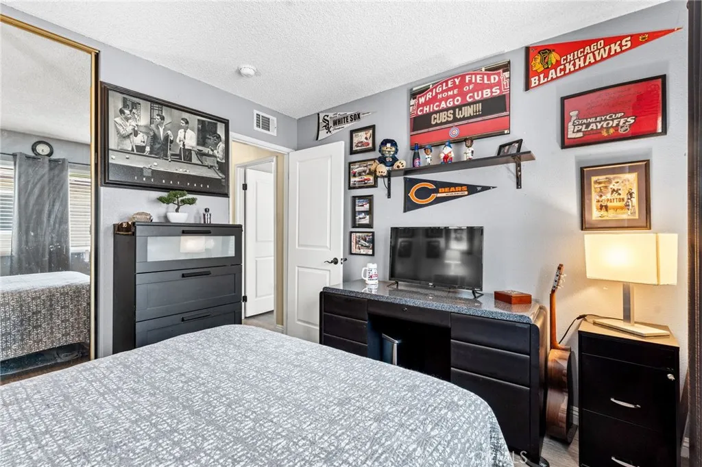 Secondary bedroom with sliding, mirrored wardrobe doors