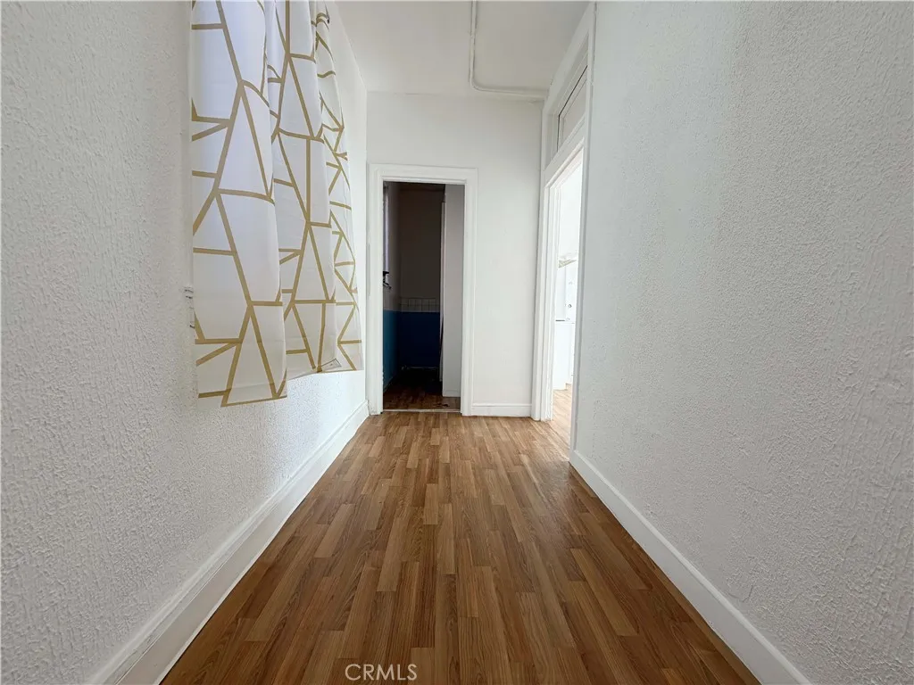 Inviting hallway Featuring wood-style flooring