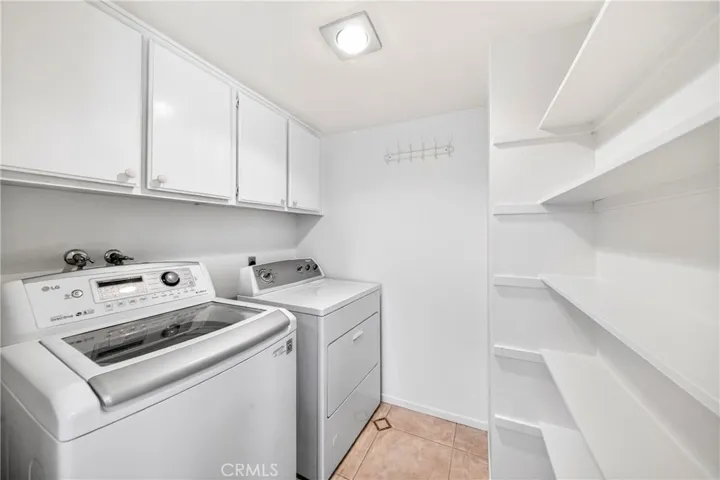 Laundry room with storage area.
