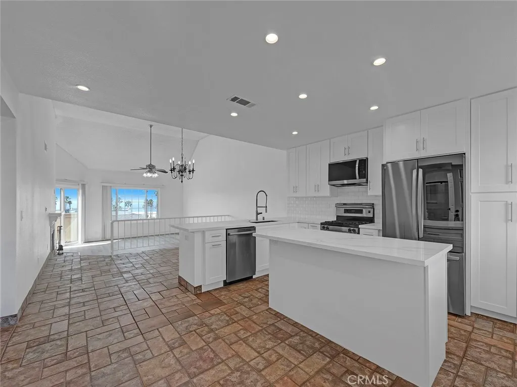 Remodeled Kitchen w island, stainless steel appliances and open to the dining and living room