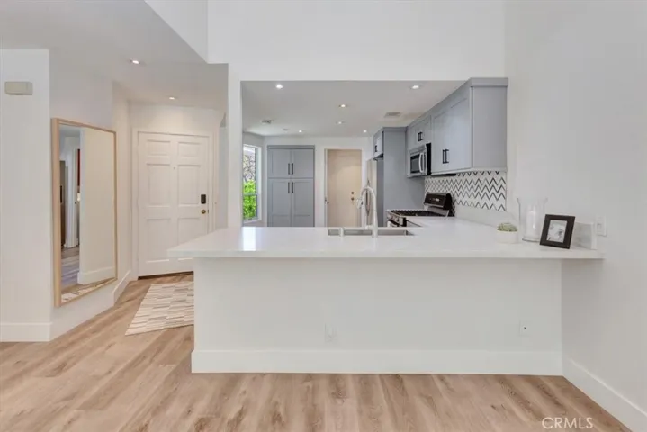 Kitchen features large bar space, perfect for entertaining friends while making them a delicious meal!