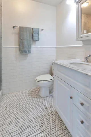 Subway tile walls, updated vanity, tiled shower and floor.
