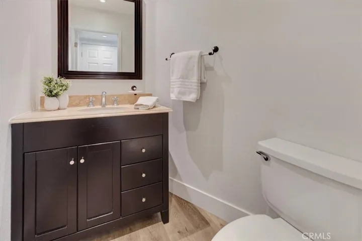 Downstairs powder room is remodeled with updated vanity, mirror and fixtures