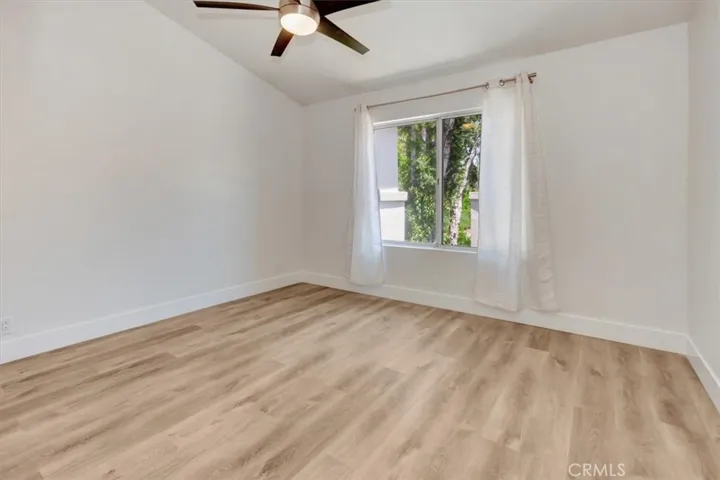 Primary Suite with high ceilings, two closets and ceiling fan.
