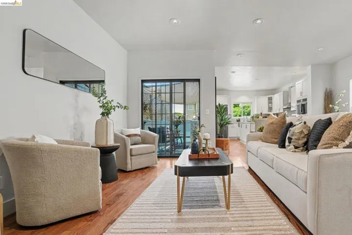 Living space featuring wood-finish flooring and recessed lighting