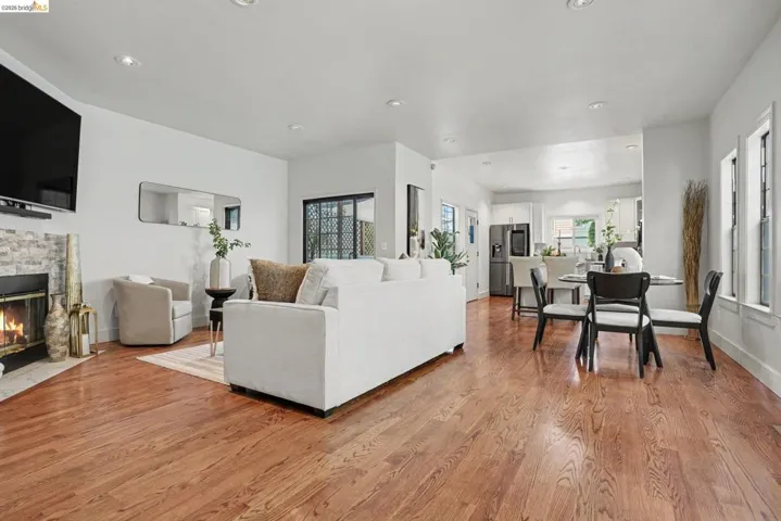 Open-concept living area featuring rich wood-finish flooring throughout