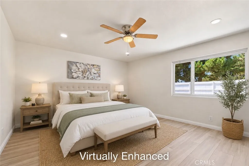 Serene primary bedroom with warm neutral tones and ceiling fan