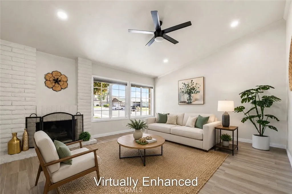 Bright open living room with ceiling fan, neutral tones, and natural light