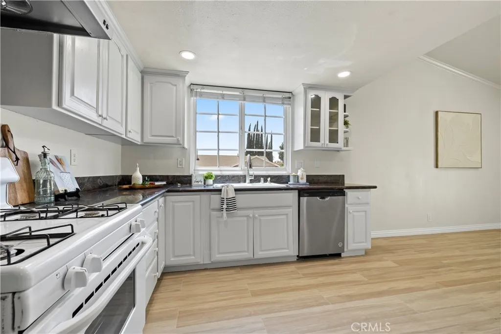 Chef's kitchen with white cabinetry and generous counter space