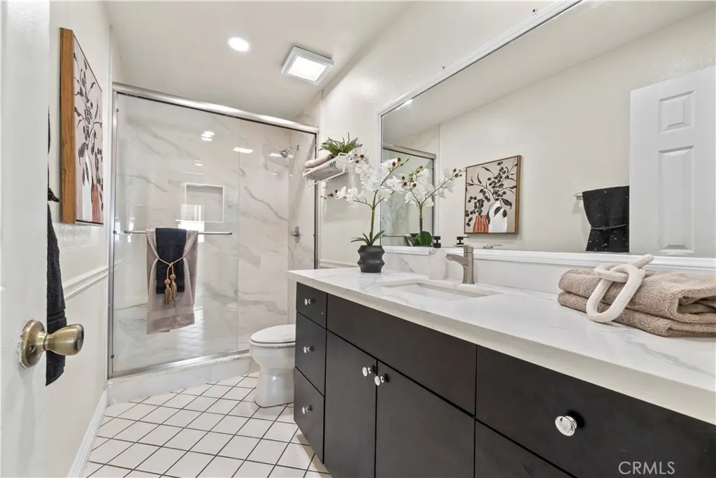Updated bathroom with dark cabinetry and modern fixtures