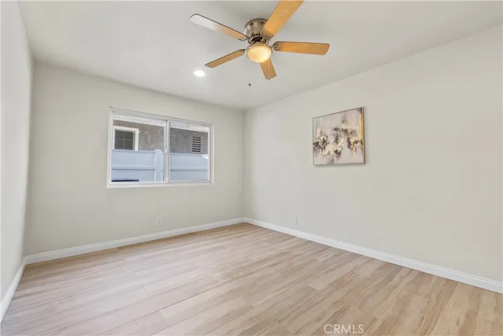 Comfortable bedroom with ceiling fan and closet storage