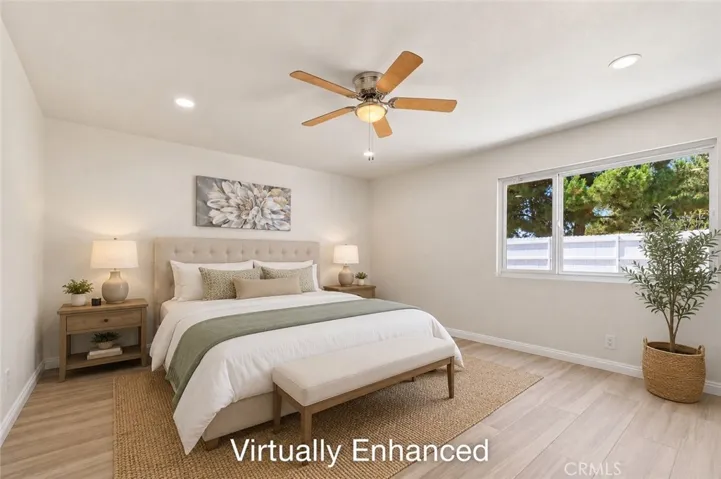 Serene primary bedroom with warm neutral tones and ceiling fan
