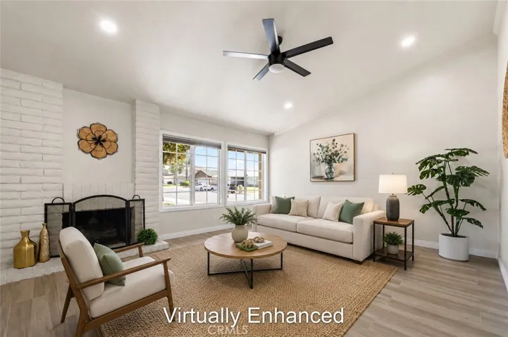 Bright open living room with ceiling fan, neutral tones, and natural light