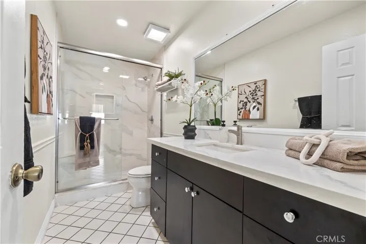 Updated bathroom with dark cabinetry and modern fixtures
