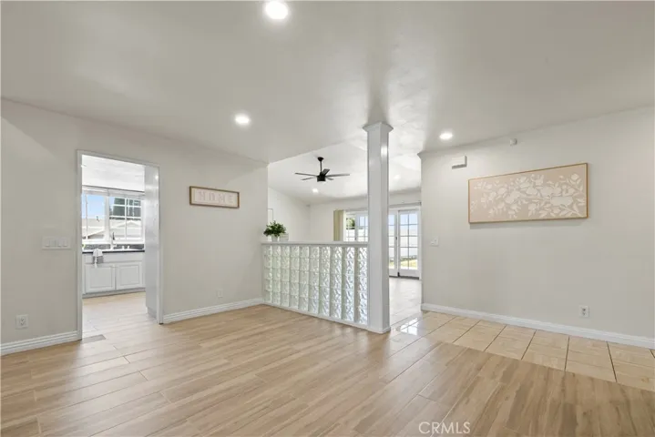 Open-concept kitchen and dining with white cabinetry and seamless flow