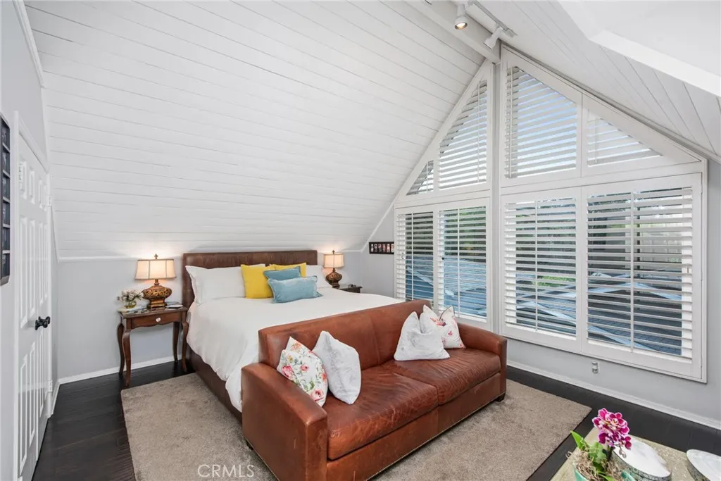 primary bedroom with king bed and vaulted ceilings