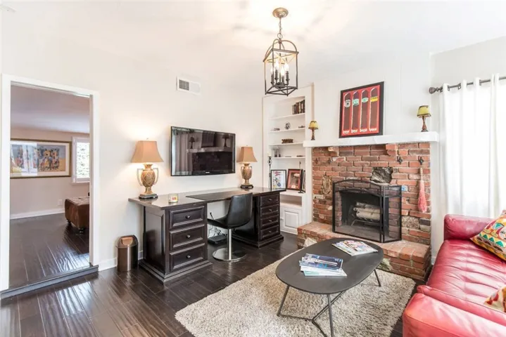 ADU with desk, leather sofa and fireplace
