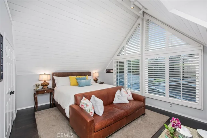 primary bedroom with king bed and vaulted ceilings