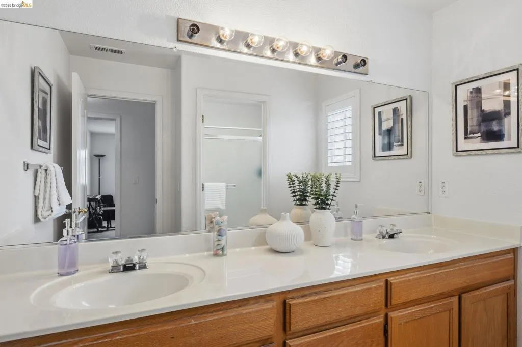 Double vanity featuring integrated sinks and a light-toned countertop