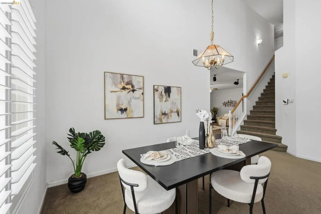Dining area featuring a vaulted ceiling and a geometric chandelier