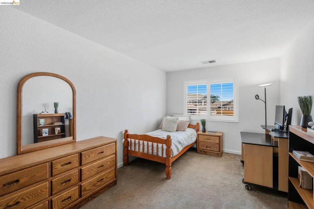 Bright room featuring neutral carpet flooring and white painted walls