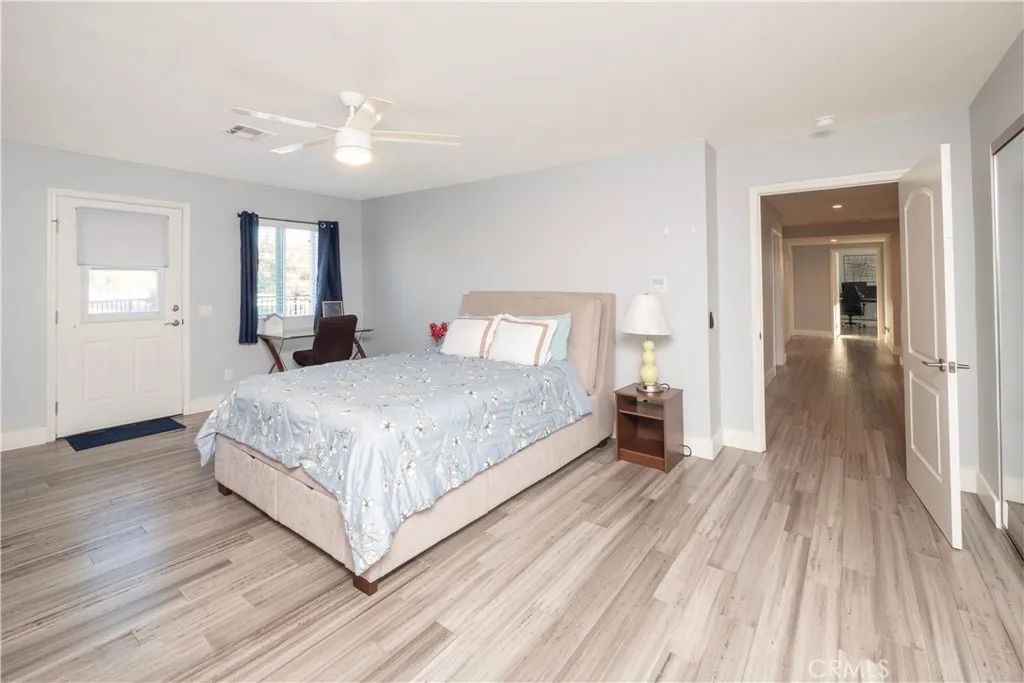 End of hall bedroom w/ door to balcony