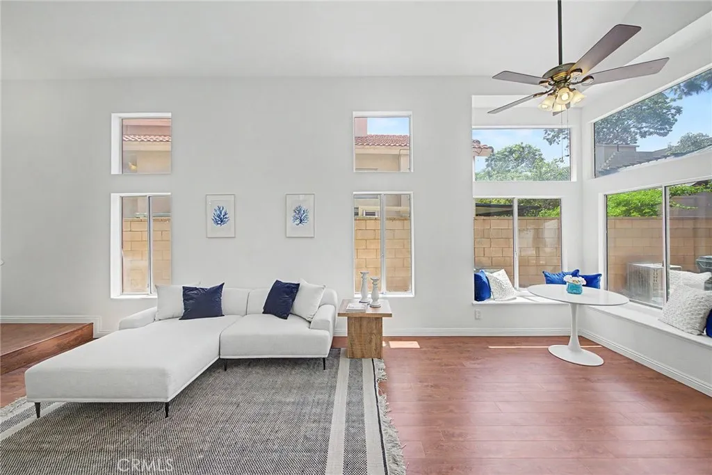Bright and airy dining room featuring built-in bench seating and a ceiling fan