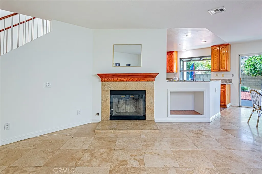 Cozy family room featuring a charming fireplace and a built-in entertainment center for audio equipment