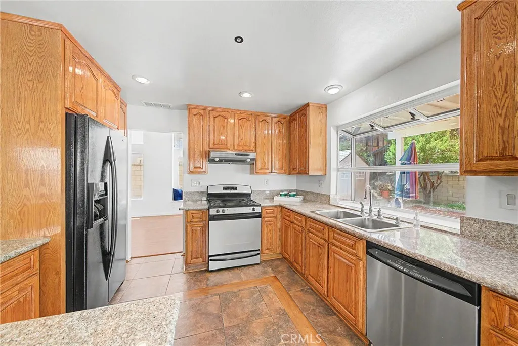 Kitchen featuring custom tile work and recessed ceiling lights